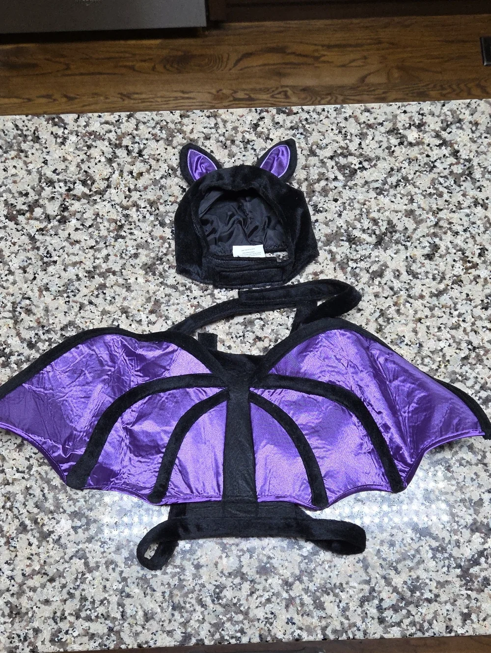 Black and purple pet bat costume features shiny metallic wing fabric